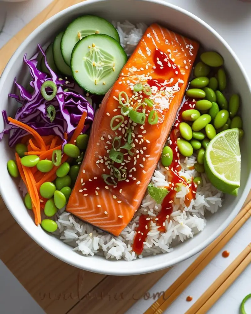 Spicy sriracha honey salmon bowl with glazed salmon, jasmine rice, colorful vegetables, and sesame seeds